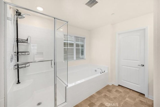 full bathroom featuring a bath, visible vents, and a stall shower