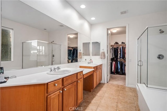 full bathroom with vanity, a shower stall, visible vents, and tile patterned floors