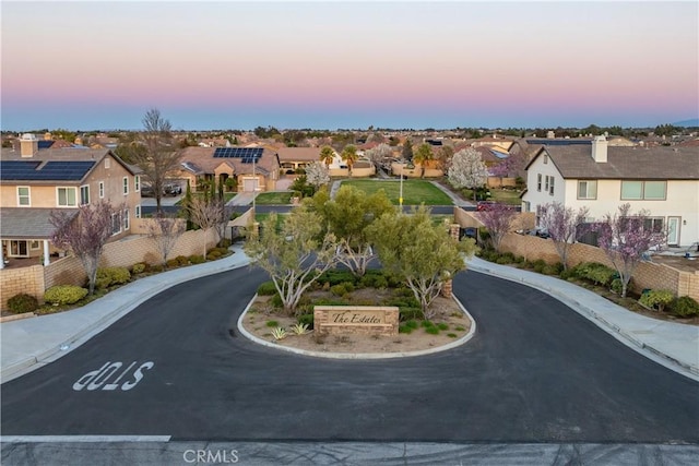 aerial view at dusk featuring a residential view