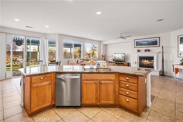 kitchen with stainless steel dishwasher, visible vents, open floor plan, and a sink