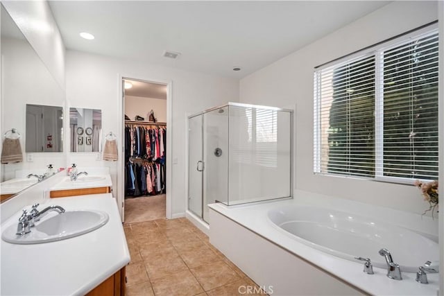 full bath with a shower stall, a garden tub, and a sink