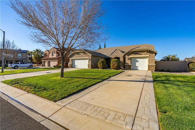 view of front facade with a front yard, fence, driveway, and stucco siding