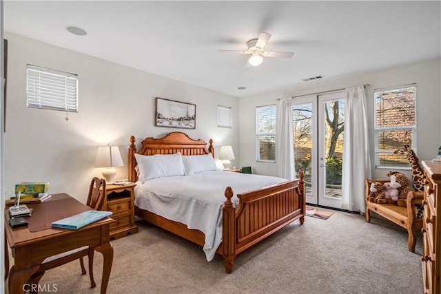 bedroom with a ceiling fan, visible vents, access to exterior, french doors, and light carpet