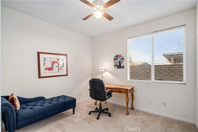 office space with carpet, baseboards, and ceiling fan