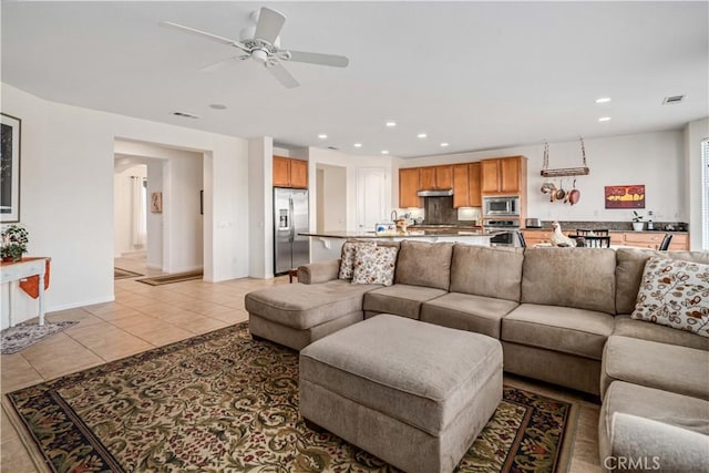 living area featuring light tile patterned floors, visible vents, a ceiling fan, and recessed lighting