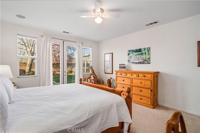 carpeted bedroom with ceiling fan, visible vents, baseboards, and access to exterior