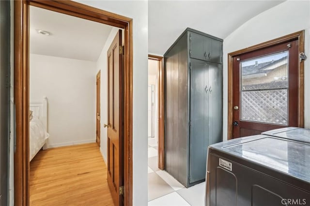 bathroom featuring vaulted ceiling, washing machine and dryer, and wood finished floors