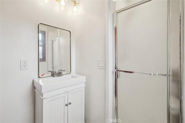 bathroom featuring a stall shower and vanity