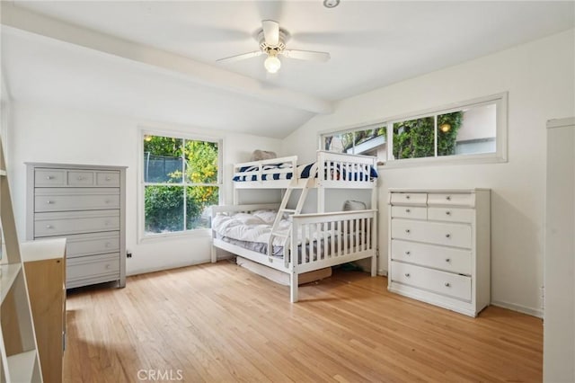 bedroom with light wood-style flooring, vaulted ceiling with beams, and a ceiling fan