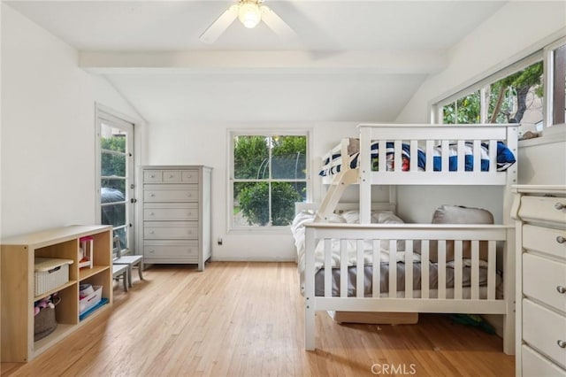 bedroom featuring lofted ceiling with beams, wood finished floors, and a ceiling fan