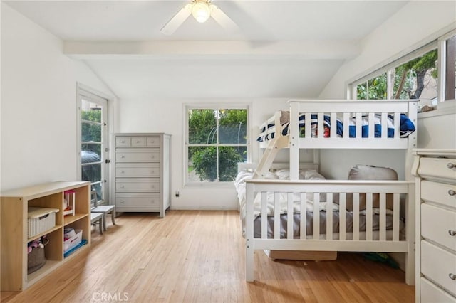 bedroom featuring hardwood / wood-style floors, vaulted ceiling with beams, and ceiling fan
