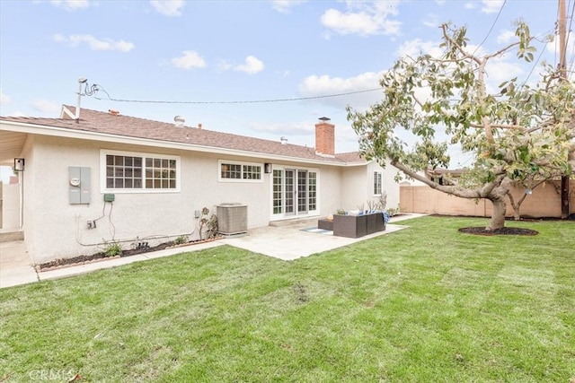 back of house with fence, an outdoor living space, stucco siding, central air condition unit, and a patio area