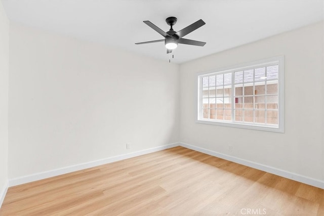 empty room with wood finished floors, baseboards, and ceiling fan