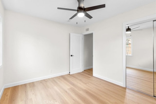 unfurnished bedroom with visible vents, baseboards, a closet, and light wood-style flooring