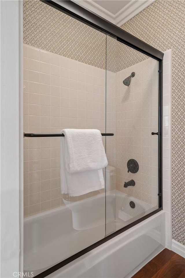 full bathroom featuring combined bath / shower with glass door and wood finished floors