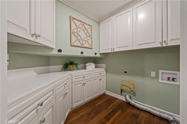 laundry area with dark wood-type flooring, cabinet space, baseboards, hookup for an electric dryer, and hookup for a washing machine