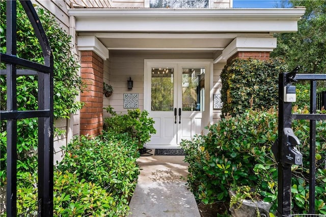 view of exterior entry with brick siding