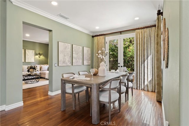 dining room with french doors, baseboards, wood finished floors, and crown molding