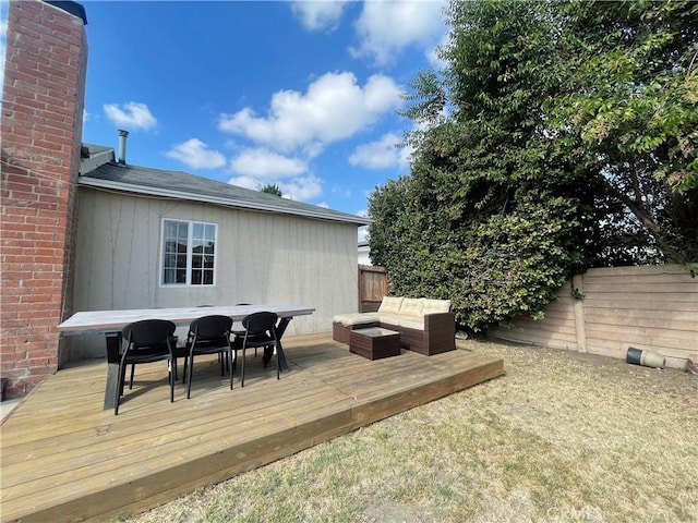 wooden terrace featuring outdoor lounge area, outdoor dining area, and a fenced backyard