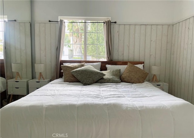 bedroom with wooden walls