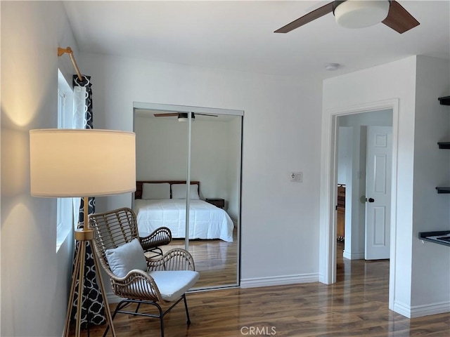 bedroom featuring ceiling fan, wood finished floors, a closet, and baseboards