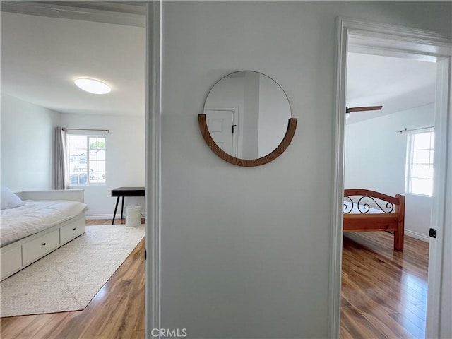 hall with wood finished floors and baseboards