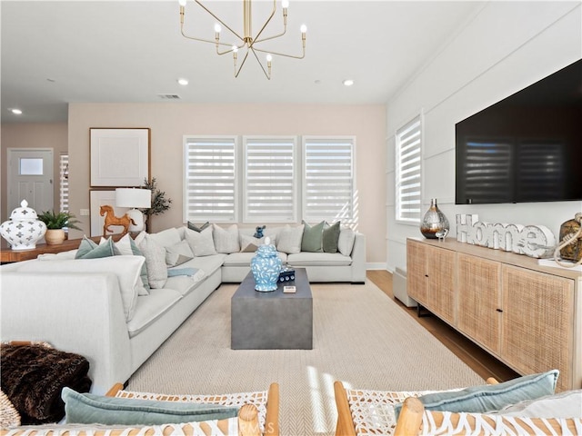 living room featuring an inviting chandelier, recessed lighting, and wood finished floors