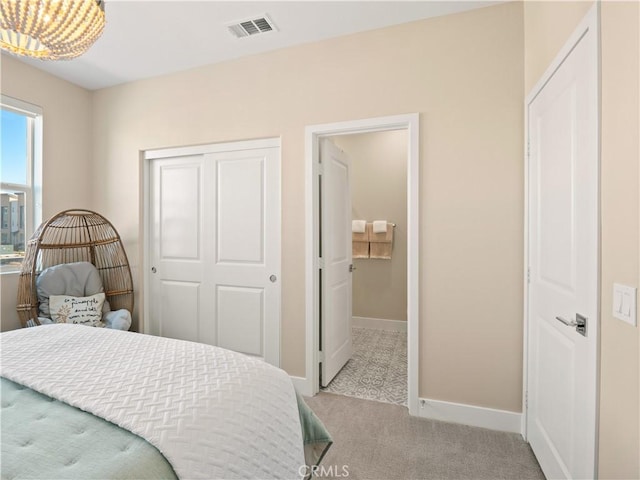 bedroom with carpet flooring, baseboards, visible vents, and a closet