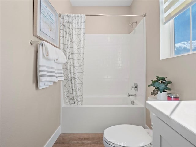 full bathroom featuring shower / bath combo with shower curtain, toilet, and vanity