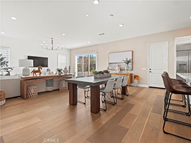 dining area with an inviting chandelier, recessed lighting, baseboards, and light wood finished floors