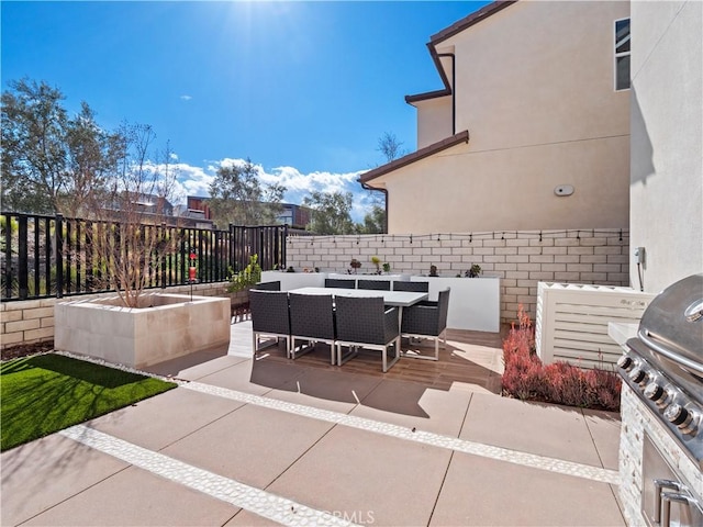 view of patio / terrace with outdoor dining area, a fenced backyard, and a grill