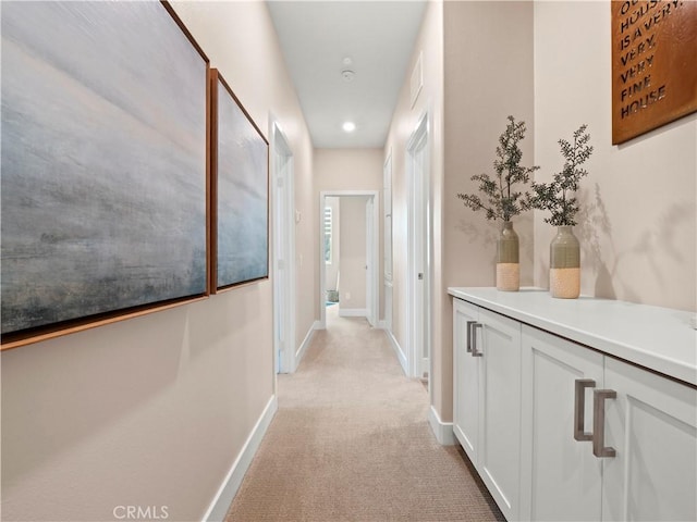 corridor with recessed lighting, baseboards, visible vents, and light carpet