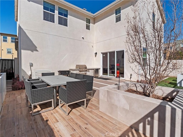 deck featuring area for grilling and outdoor dining area