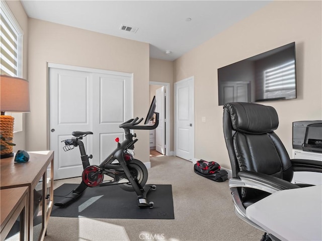 exercise room with visible vents and baseboards