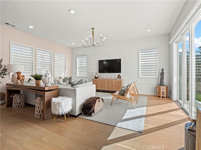 living area featuring a wealth of natural light and light wood finished floors