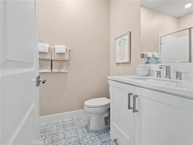 bathroom featuring vanity, baseboards, a tile shower, tile patterned floors, and toilet