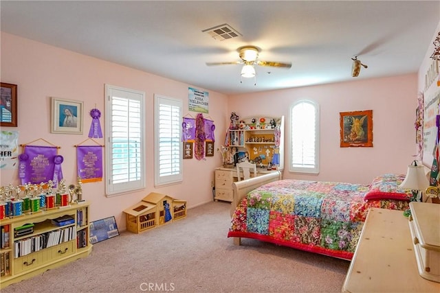 carpeted bedroom featuring visible vents and a ceiling fan