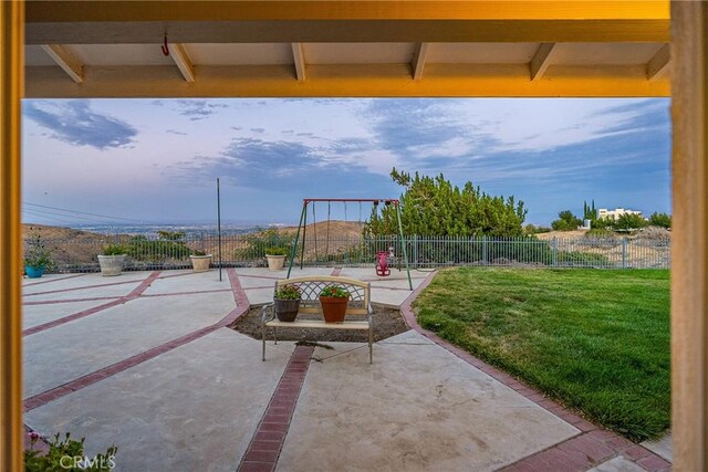 view of patio featuring fence and playground community