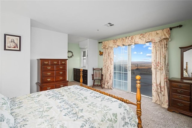 carpeted bedroom with access to outside and visible vents