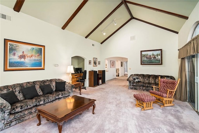 living area with visible vents, arched walkways, light carpet, and beam ceiling