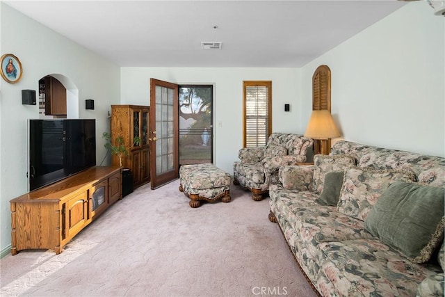 living area with light colored carpet and visible vents