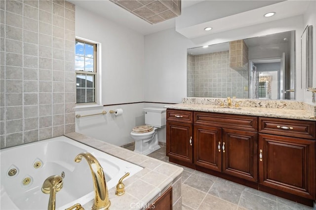 full bathroom with a tub with jets, recessed lighting, toilet, and vanity