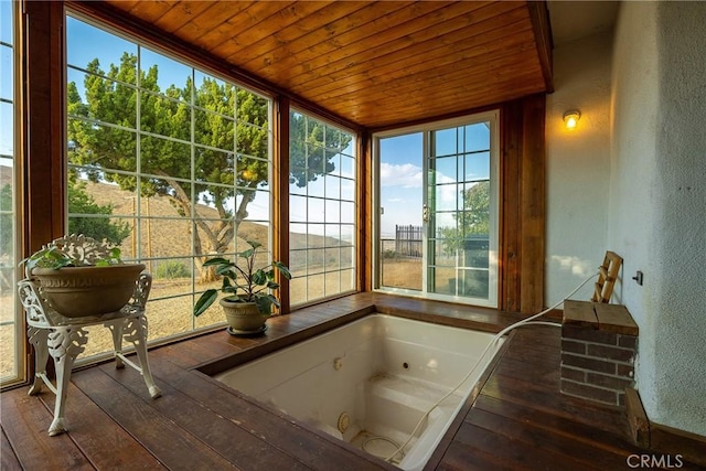 sunroom / solarium with wooden ceiling and a hot tub