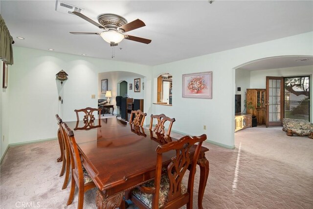 dining room with recessed lighting, visible vents, arched walkways, and light carpet