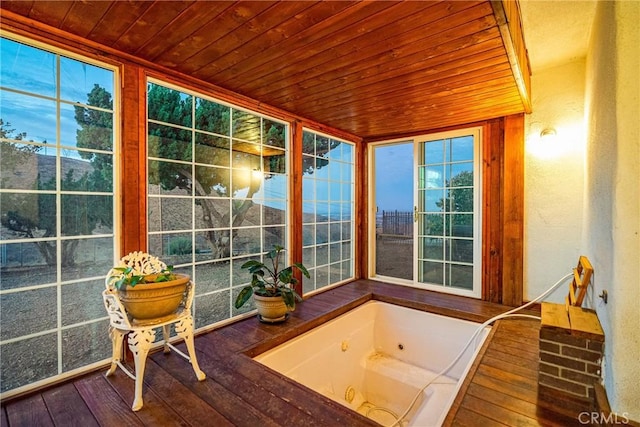 sunroom / solarium featuring wooden ceiling and a hot tub