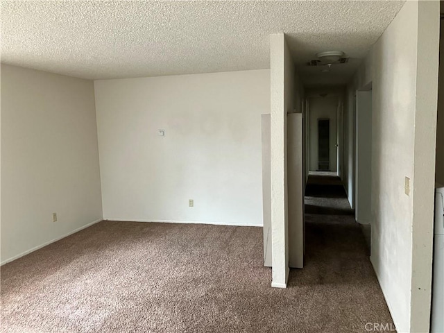 unfurnished room featuring a textured ceiling and carpet flooring