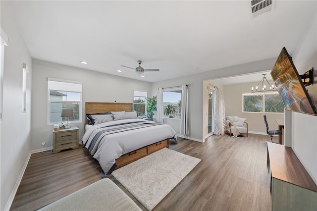 11119 Iris Ct, Corona, CA 92883 - bedroom with multiple windows, wood finished floors, recessed lighting, a chandelier, and a ceiling fan