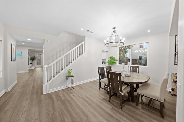 11119 Iris Ct, Corona, CA 92883 - dining room with stairs, light wood-style flooring, a chandelier, and recessed lighting