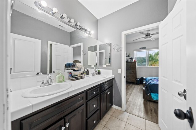 11119 Iris Ct, Corona, CA 92883 - full bath with double vanity, a ceiling fan, tile patterned floors, and ensuite bath