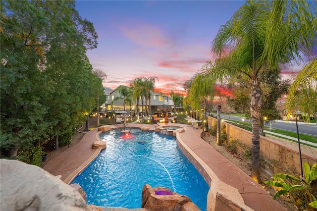 11119 Iris Ct, Corona, CA 92883 - pool at dusk featuring a pool with connected hot tub